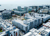 Thumbnail 48 of 50 - A cityscape with buildings and a body of water in the background.