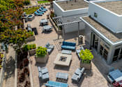Thumbnail 44 of 50 - A patio area with tables and chairs is shown from an aerial perspective.