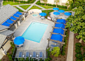 Thumbnail 20 of 39 - an aerial view of a swimming pool with blue umbrellas at Sunstone Place, California, 92505