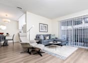 Thumbnail 4 of 39 - a living room with a couch and a chair and a dining room table at Sunstone Place, Riverside, CA, 92505