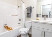 Thumbnail 14 of 39 - a bathroom with a toilet and a tub and a sink at Sunstone Place, Riverside, California