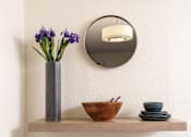 Thumbnail 6 of 39 - a shelf with a mirror and a vase with flowers on it at Sunstone Place, Riverside