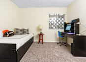 Thumbnail 9 of 39 - a bedroom with a bed and a desk with a computer at Sunstone Place, Riverside, California