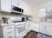 Thumbnail 11 of 39 - a kitchen with white cabinets and white appliances at Sunstone Place, Riverside, 92505