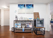 Thumbnail 12 of 142 - A room with a table and a display of items for sale.