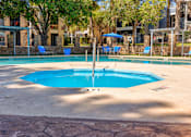 Thumbnail 16 of 142 - A round blue pool with a fountain in the middle.