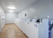 Thumbnail 18 of 142 - A row of washing machines in a laundromat.