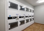 Thumbnail 19 of 142 - A row of white ovens are lined up in a room.