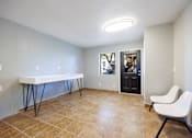 Thumbnail 21 of 142 - A room with a white table and a white chair.