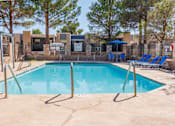 Thumbnail 29 of 142 - A pool surrounded by trees and a fence.