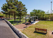 Thumbnail 47 of 142 - A park with a bench, a playground and a tree.