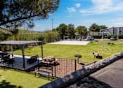 Thumbnail 48 of 142 - A park with a playground and picnic tables.
