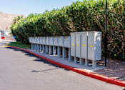 Thumbnail 53 of 142 - A row of grey utility boxes are lined up on the side of a road.