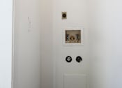 Thumbnail 113 of 142 - A white bathroom with a toilet and a shower head.