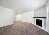 Thumbnail 114 of 142 - A large, empty room with a fireplace on the right side.