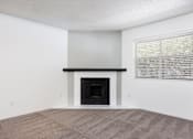 Thumbnail 115 of 142 - A room with a fireplace and a window with blinds.