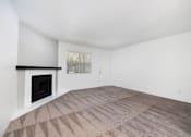 Thumbnail 116 of 142 - A room with a fireplace and carpeted floor.