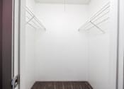 Thumbnail 118 of 142 - Empty refrigerator with shelves and a mat on the floor.