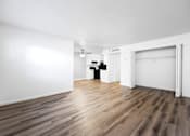 Thumbnail 128 of 142 - A room with wooden flooring and white walls.