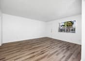 Thumbnail 129 of 142 - A room with wooden flooring and white walls.