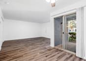 Thumbnail 130 of 142 - A room with a sliding glass door leading outside.