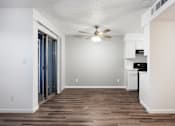 Thumbnail 131 of 142 - A room with a ceiling fan and a wooden floor.