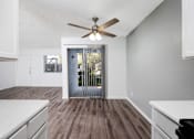 Thumbnail 136 of 142 - A room with a ceiling fan and wooden flooring.