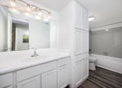 Thumbnail 137 of 142 - A white bathroom with a sink, toilet, and bathtub.