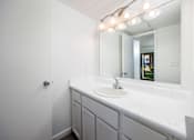 Thumbnail 139 of 142 - A bathroom with a white sink and mirror.