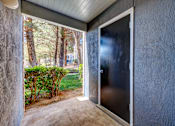 Thumbnail 140 of 142 - A patio with a door leading to a backyard.