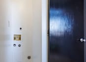 Thumbnail 142 of 142 - A black door is in a white room.