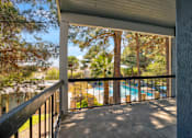 Thumbnail 95 of 142 - A balcony with a pool in the background.