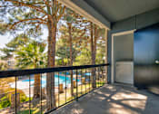 Thumbnail 96 of 142 - A balcony with a pool and trees in the background.