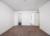 Thumbnail 100 of 142 - A room with carpeted floor and three doors.