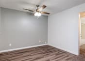 Thumbnail 106 of 142 - A room with a ceiling fan and light fixture.
