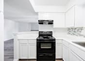 Thumbnail 111 of 142 - A black oven in a white kitchen.
