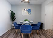 Thumbnail 77 of 142 - A dining room with a table and blue chairs.