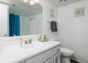 Thumbnail 78 of 142 - A white bathroom with a white sink and toilet.