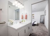 Thumbnail 82 of 142 - A bathroom with a white sink and a mirror above it.