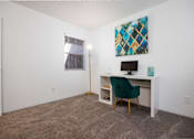 Thumbnail 86 of 142 - A room with a desk and a chair.