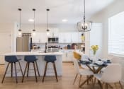 Thumbnail 20 of 39 - a kitchen and dining area with a table and chairs at Terracina, Broomfield, Colorado