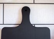 Thumbnail 25 of 39 - a black serving board with white tiles in the background at Terracina, Colorado 80020
