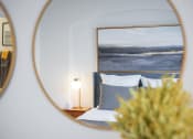 Thumbnail 33 of 39 - a bedroom with a bed and a mirror on the wall at Terracina, Broomfield, CO