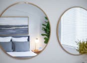 Thumbnail 32 of 39 - a room with a bed and two mirrors on the wall at Terracina, Broomfield