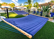 Thumbnail 26 of 27 - A blue inflatable slide in a backyard at Nola 624 Apartments, West Covina, CA, 91790
