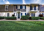 Thumbnail 16 of 27 - A row of houses with blue shutters and white walls at Nola 624 Apartments, West Covina, CA, 91790
