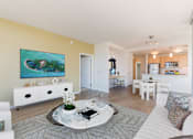 Thumbnail 31 of 104 - A living room with a white sofa and a coffee table with a book on it at The Grand Apartments, California