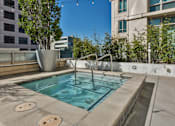 Thumbnail 95 of 104 - A small pool with a diving board and a tree in a pot at The Grand Apartments, Oakland, California