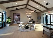 Thumbnail 8 of 87 - Clubroom with a large window and a dining table set up.