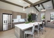 Thumbnail 7 of 87 - Clubroom with a large island and grey chairs.